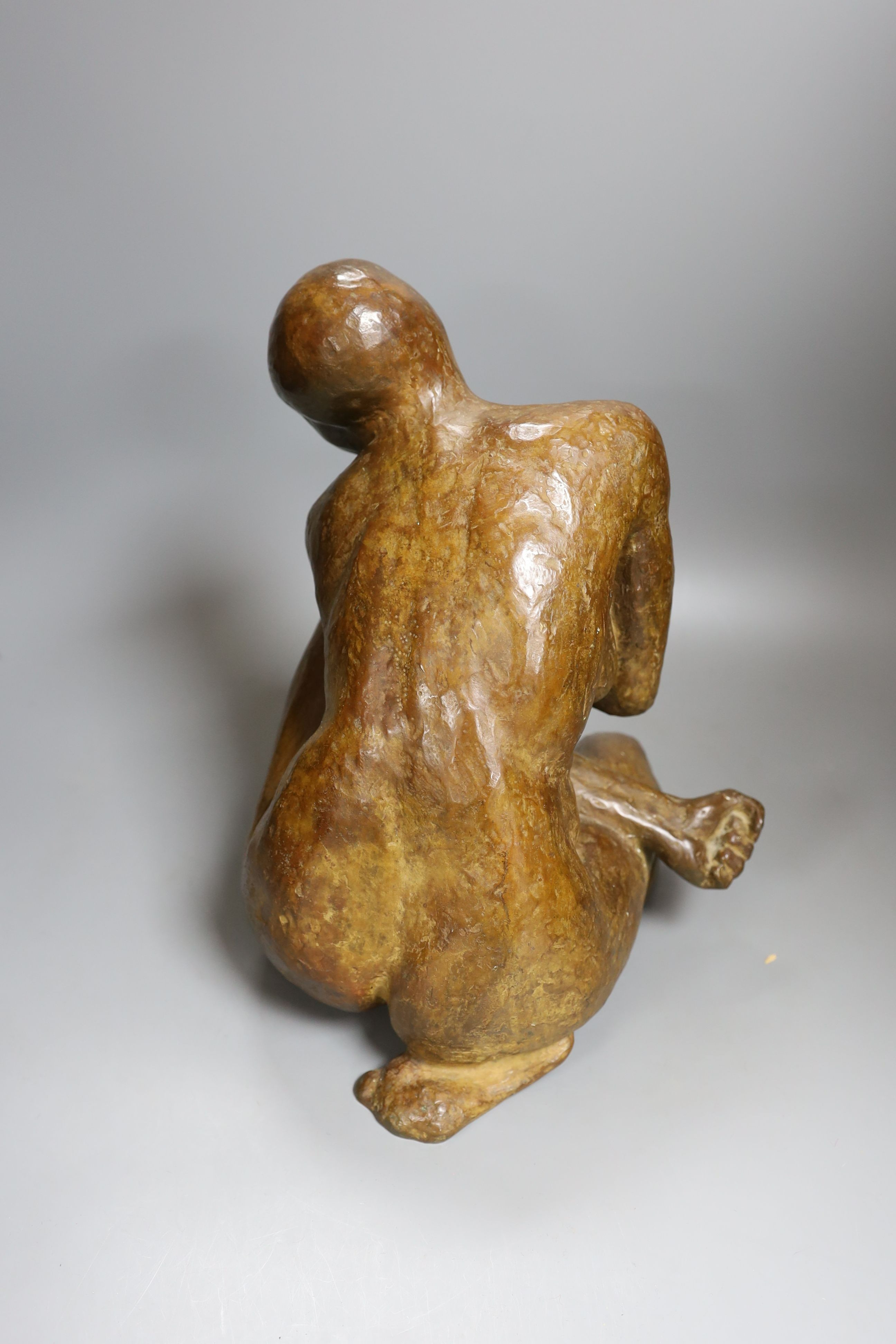 A contemporary bronze of a lady crouching with a thoughtful expression, unsigned - 31cm high